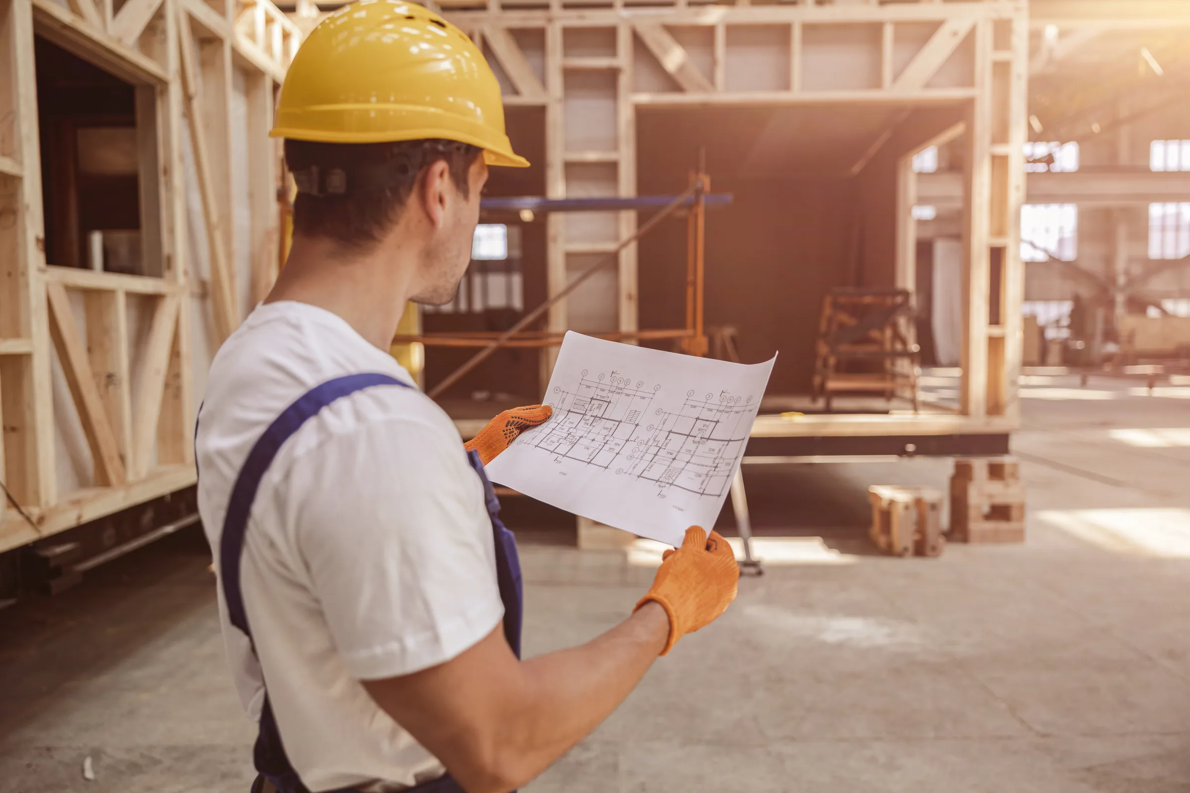 A craftsperson installing cabinetry and tile
